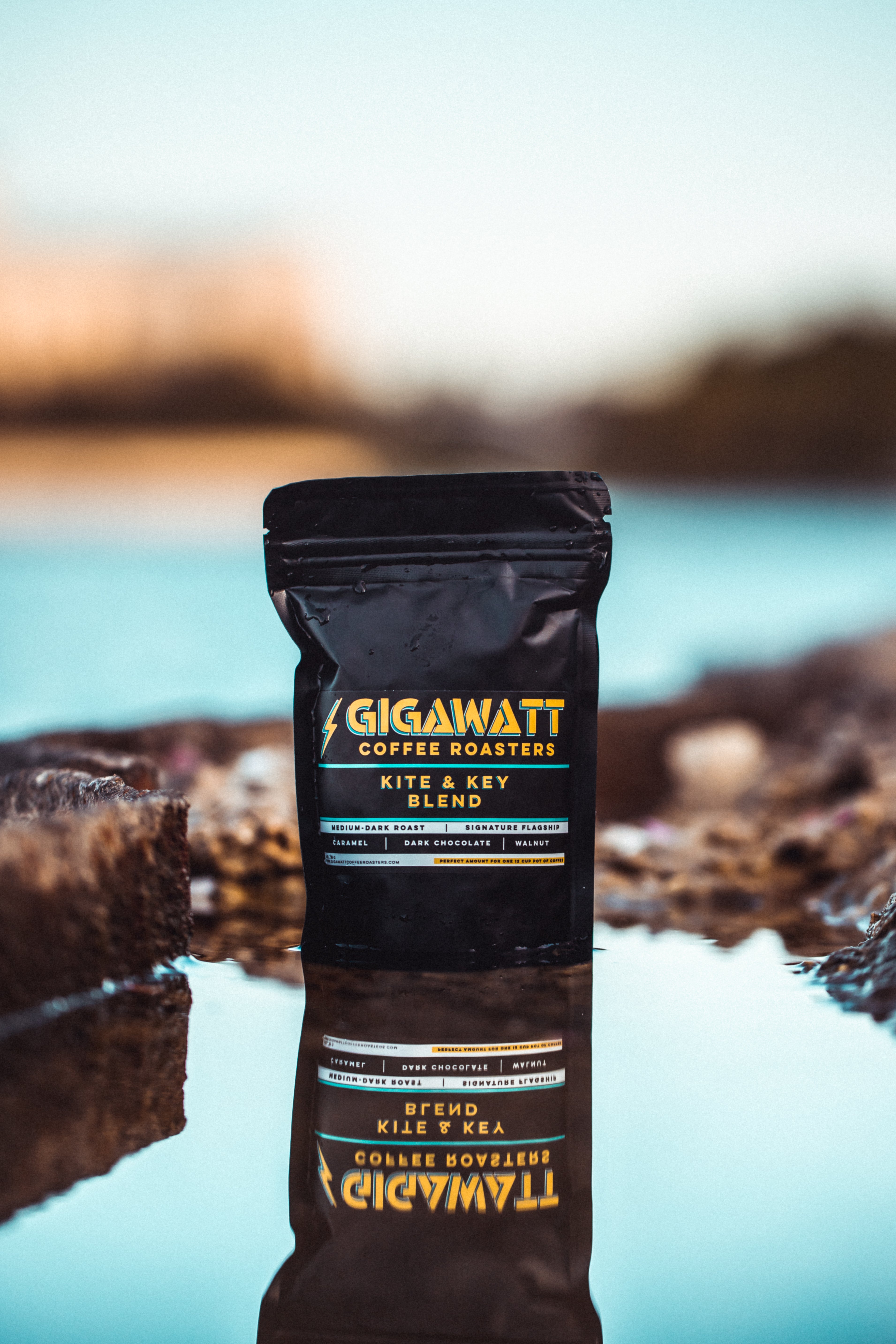 Gigawatt Coffee Kite and Key Blend standing in water with reflection.