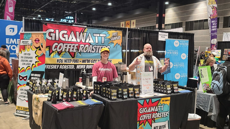 Gigawatt Coffee Roasters full booth setup at C2E2 with comic-style banners coffee bags and team members at McCormick Place