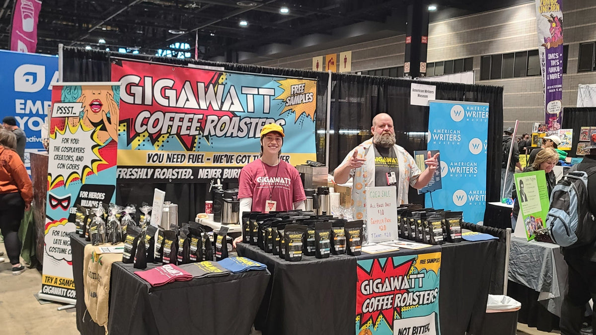 Gigawatt Coffee Roasters full booth setup at C2E2 with comic-style banners coffee bags and team members at McCormick Place