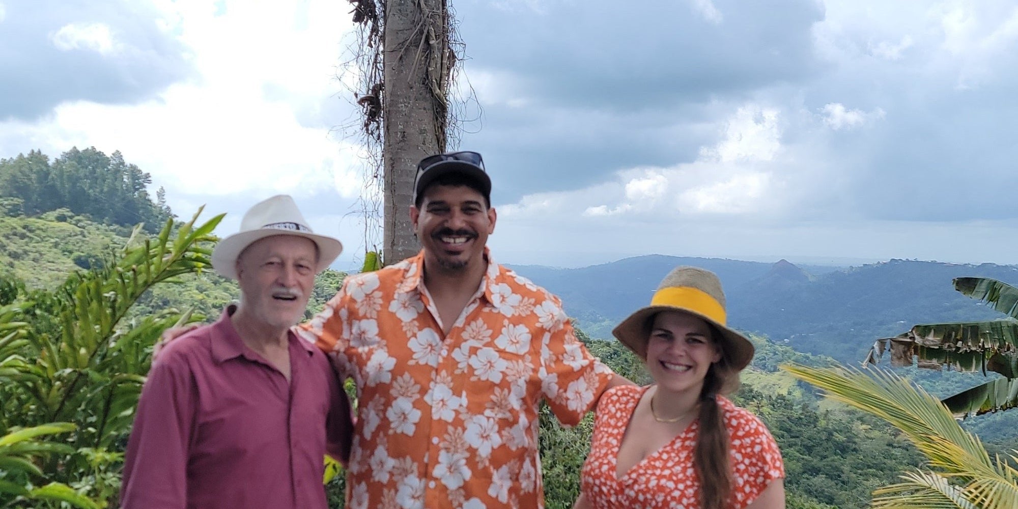 Israel Gonzalez with Eli and Jen Coleman on the overlook at Sandra Farms in Adjuntas, Puerto Rico