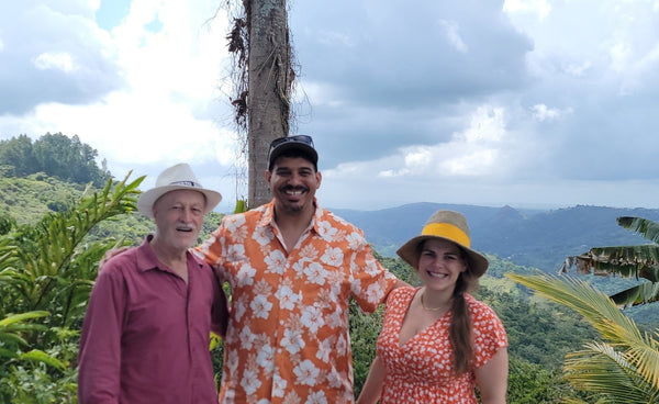 Israel Gonzalez with Eli and Jen Coleman on the overlook at Sandra Farms in Adjuntas, Puerto Rico
