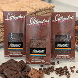 Coffee Chocolate Bar Collection 3-bar variety pack by Gigawatt Coffee Roasters and Littlejohn's Candies on a surface with chocolate and coffee beans