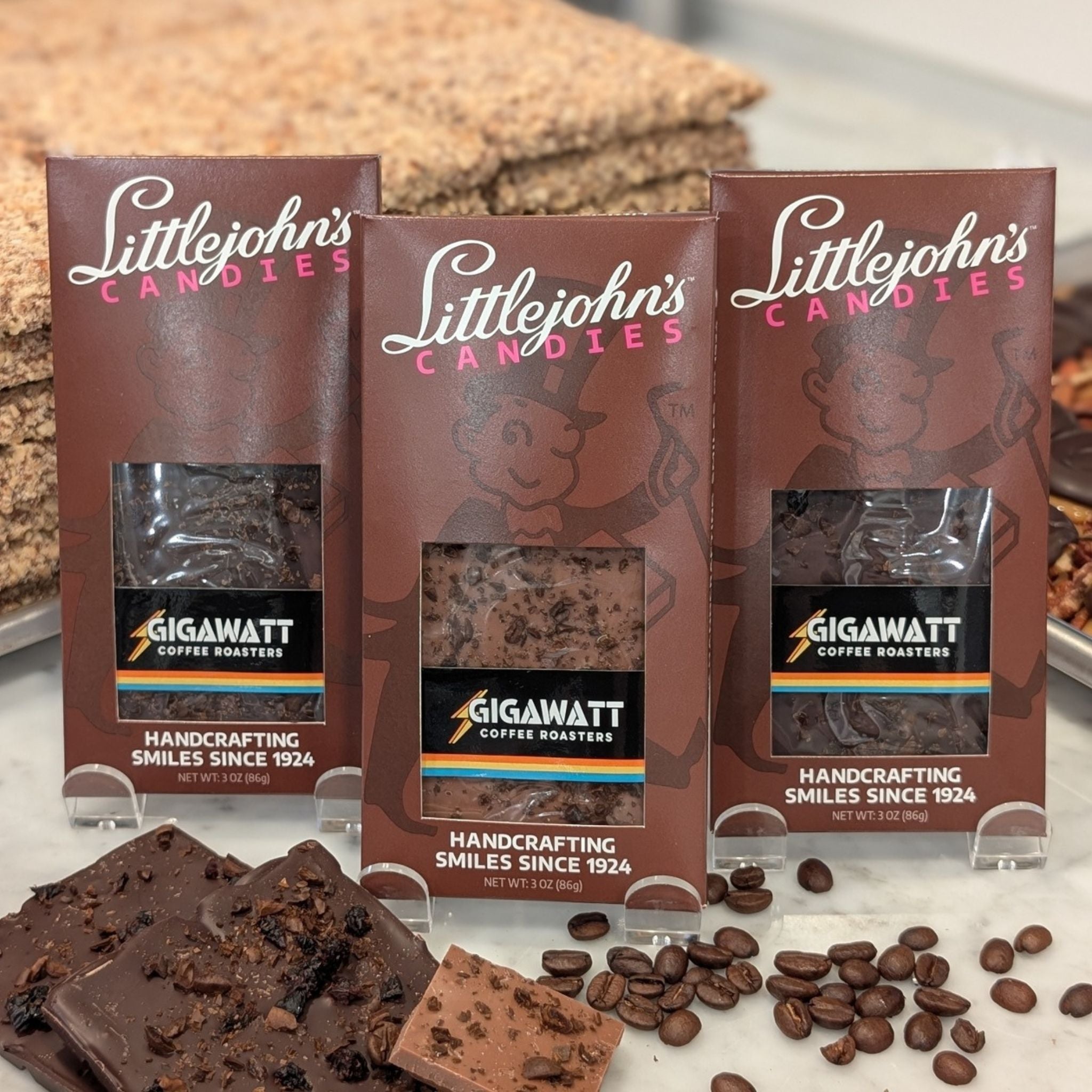 Coffee Chocolate Bar Collection 3-bar variety pack by Gigawatt Coffee Roasters and Littlejohn's Candies on a surface with chocolate and coffee beans
