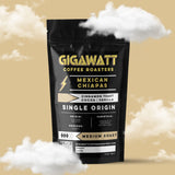 Gigawatt Coffee Mexican Chiapas Coffee, single origin medium roast with smooth cinnamon toast, vanilla, and cacao notes. 10 oz, displayed on a counter.