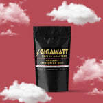 Gigawatt Coffee Organic Ethiopian Guji Coffee, medium roast single origin with raspberry, cream, and chocolate tart notes. 3 oz, set against a cloud-filled background.