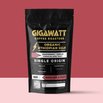 Gigawatt Coffee Organic Ethiopian Guji Coffee, medium roast single origin with raspberry, cream, and chocolate tart notes. 10 oz, displayed on a counter.