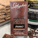 Milk chocolate bar made with organic Honduran coffee by Gigawatt Coffee Roasters and Littlejohn's Candies on a surface with chocolate and coffee beans